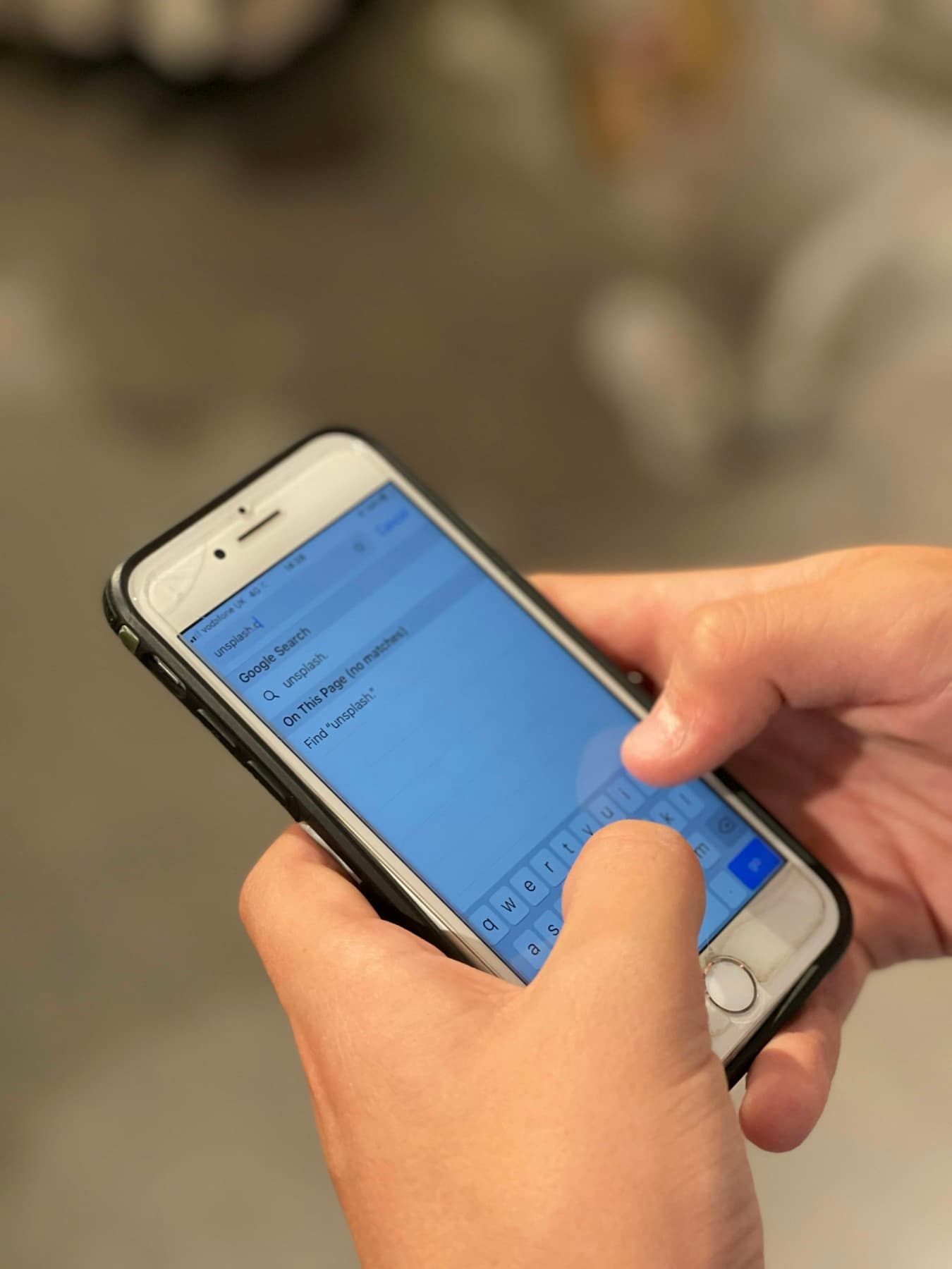 A person typing a message on a phone